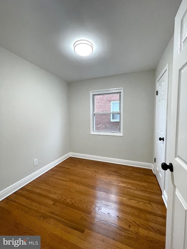 unfurnished room featuring dark hardwood / wood-style floors