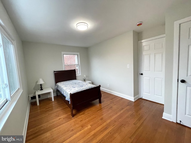 bedroom featuring wood finished floors and baseboards