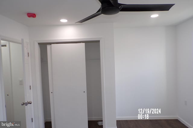 unfurnished bedroom featuring ceiling fan, a closet, and dark hardwood / wood-style floors