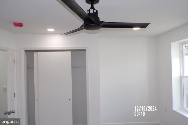 unfurnished bedroom with multiple windows, a closet, and ceiling fan