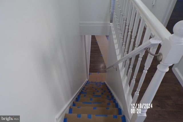 stairs featuring hardwood / wood-style flooring