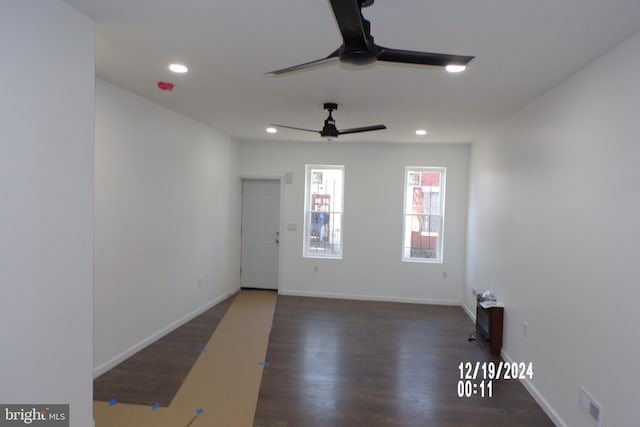 empty room featuring ceiling fan and dark wood-type flooring