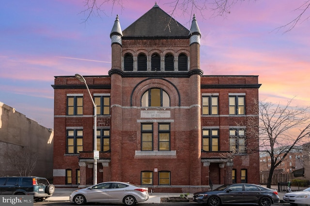 view of outdoor building at dusk