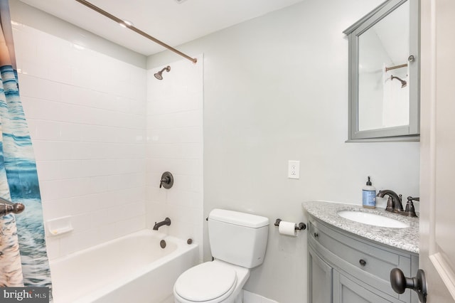 full bathroom with vanity, shower / bath combo, and toilet