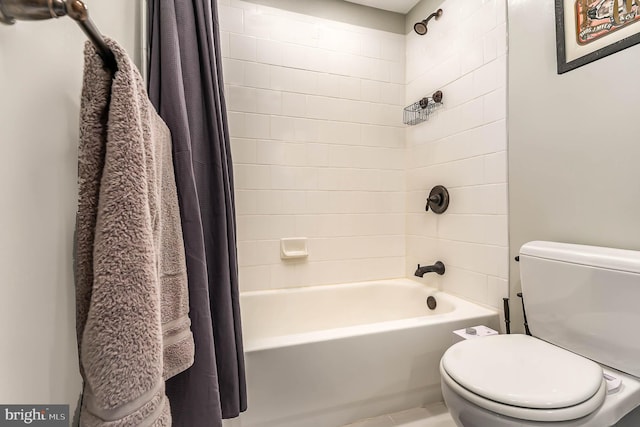 bathroom featuring shower / bathtub combination with curtain and toilet