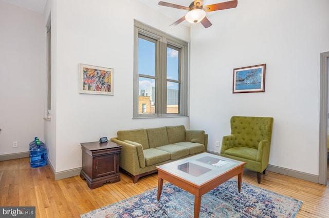 living room with ceiling fan and light hardwood / wood-style floors