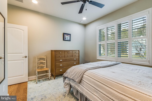 bedroom with ceiling fan and light hardwood / wood-style flooring