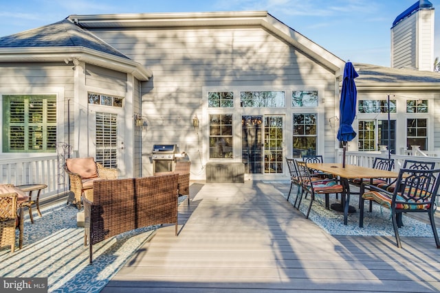 wooden deck with a grill