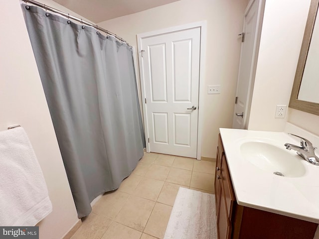 bathroom featuring tile patterned flooring and vanity