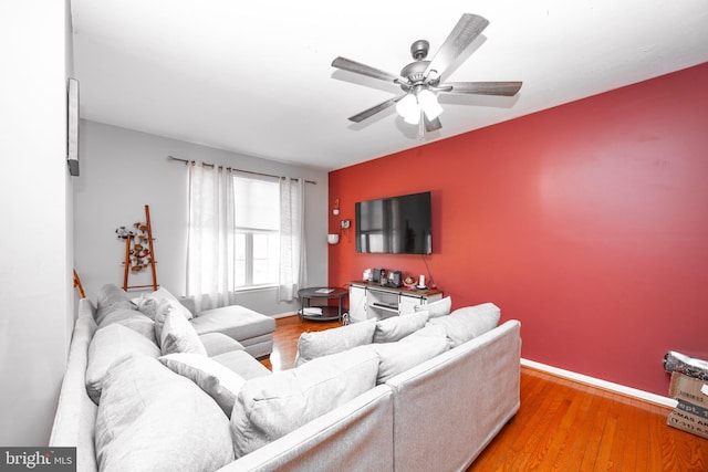 living room featuring ceiling fan and hardwood / wood-style floors