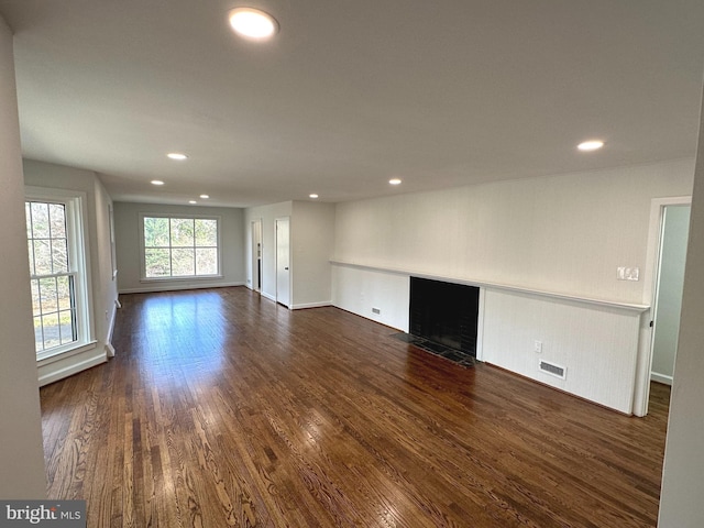 unfurnished living room with dark hardwood / wood-style floors