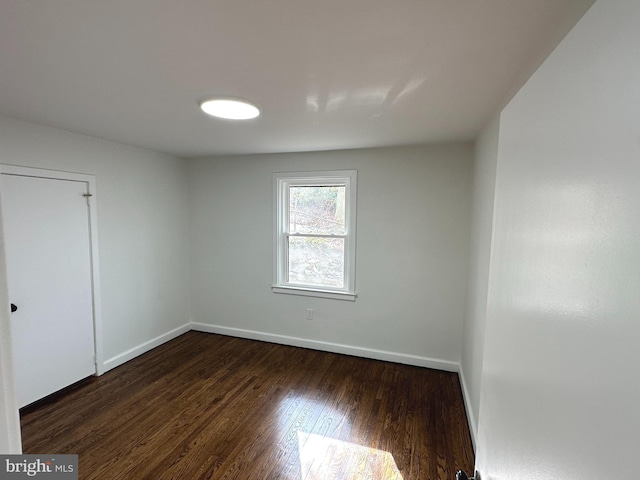 spare room with dark hardwood / wood-style flooring