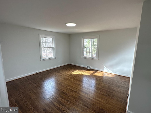 spare room with dark hardwood / wood-style flooring