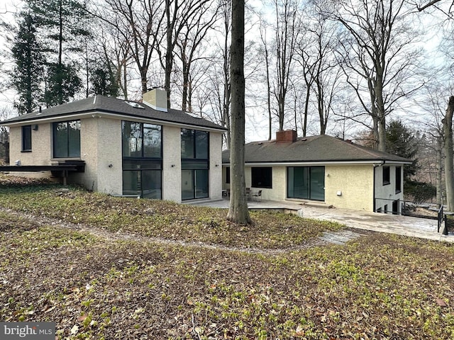 rear view of property featuring a patio