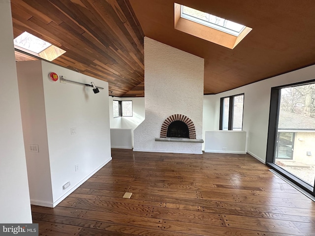 unfurnished living room featuring a fireplace, wooden ceiling, plenty of natural light, and hardwood / wood-style flooring