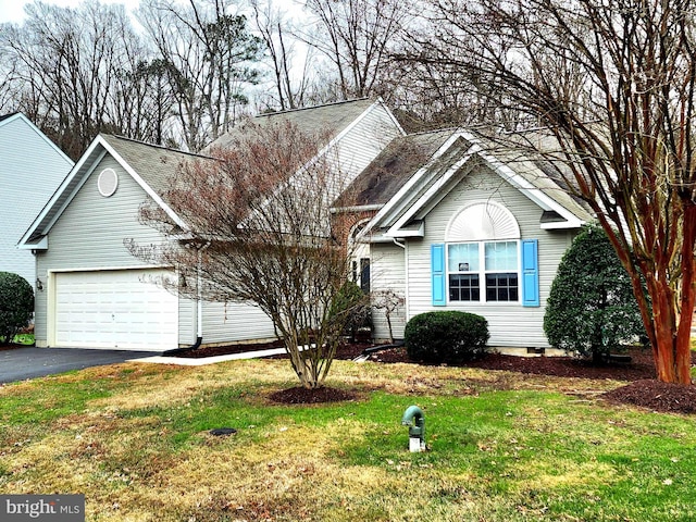 view of front of property with a garage and a front lawn