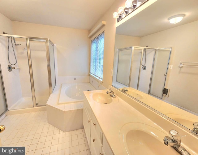 bathroom with tile patterned floors, vanity, and separate shower and tub