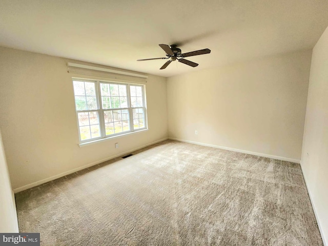 unfurnished room featuring ceiling fan and carpet floors