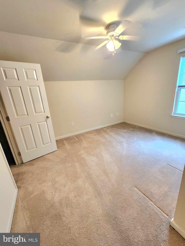 bonus room with ceiling fan, light carpet, and vaulted ceiling