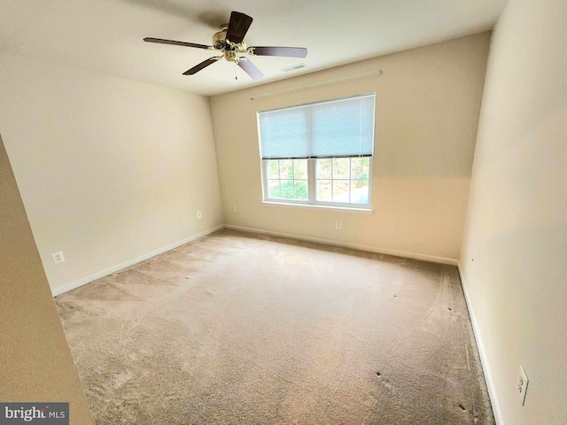 empty room with light colored carpet and ceiling fan