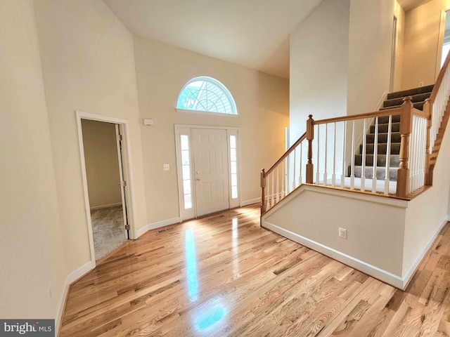 entrance foyer with light hardwood / wood-style floors and a high ceiling