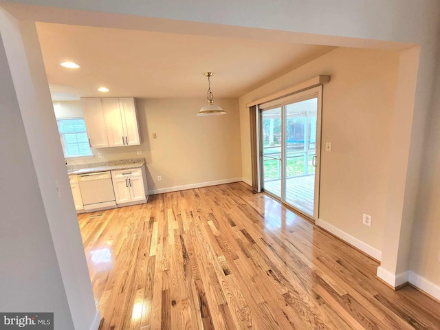 unfurnished dining area featuring light hardwood / wood-style flooring