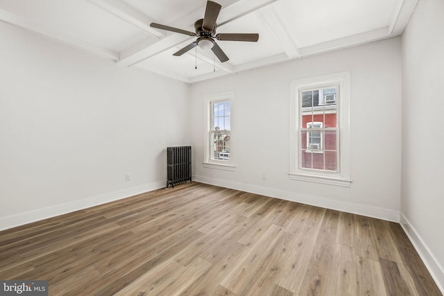 spare room featuring ceiling fan, beamed ceiling, light hardwood / wood-style floors, and coffered ceiling