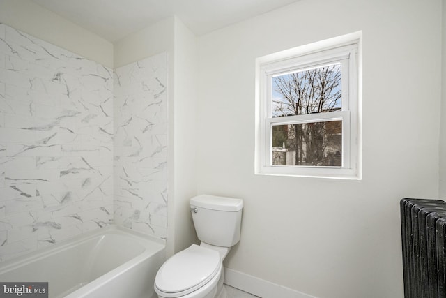 bathroom with a bathtub, toilet, and radiator