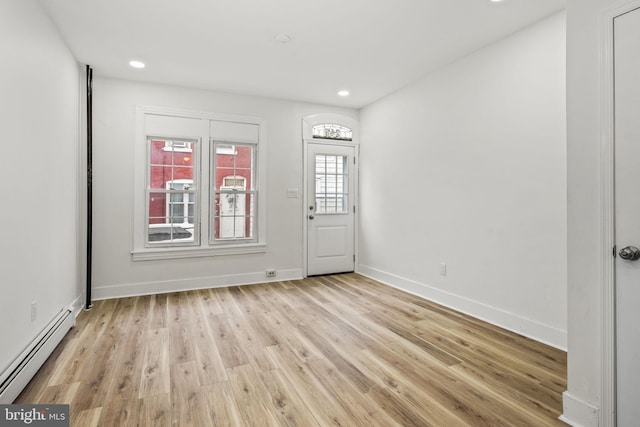 interior space featuring light hardwood / wood-style flooring and a baseboard heating unit