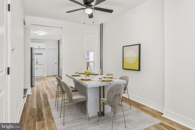 dining area featuring ceiling fan and light hardwood / wood-style flooring