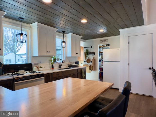 kitchen with wood ceiling, white appliances, sink, decorative light fixtures, and white cabinets