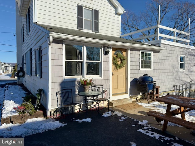 view of snow covered property entrance