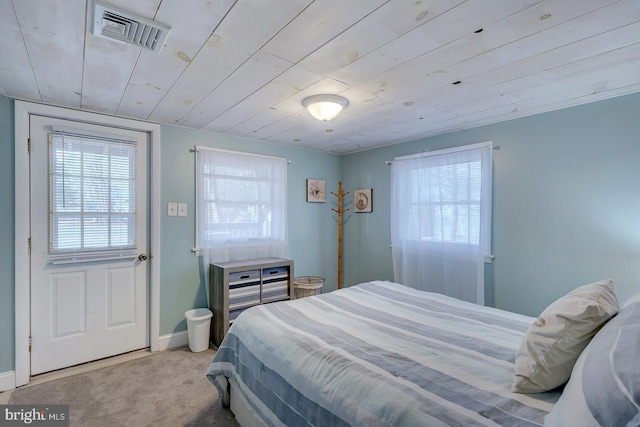 carpeted bedroom with wood ceiling