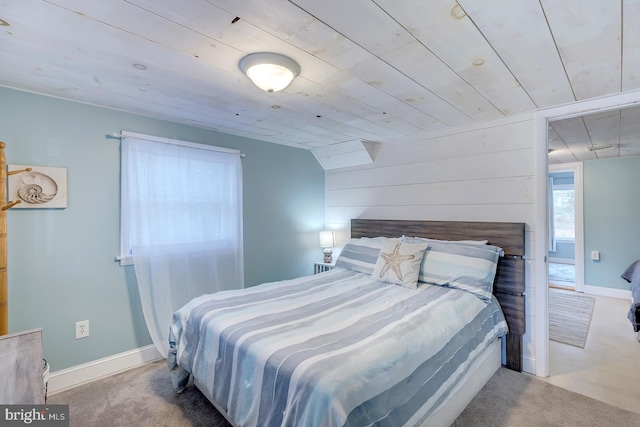 bedroom featuring carpet floors, vaulted ceiling, and wooden ceiling