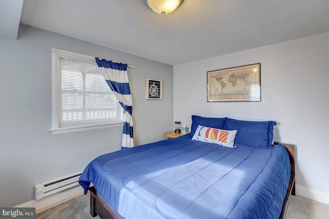 bedroom with carpet floors and a baseboard radiator