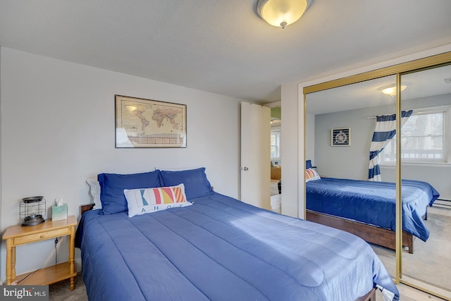 bedroom featuring carpet flooring and a closet