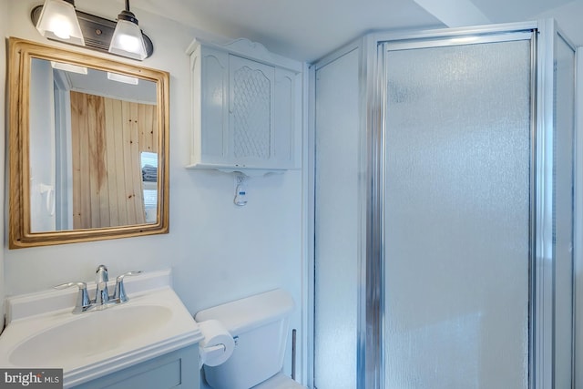 bathroom with vanity, toilet, and walk in shower