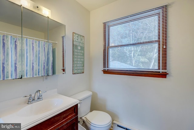 bathroom featuring a shower with shower curtain, vanity, toilet, and baseboard heating