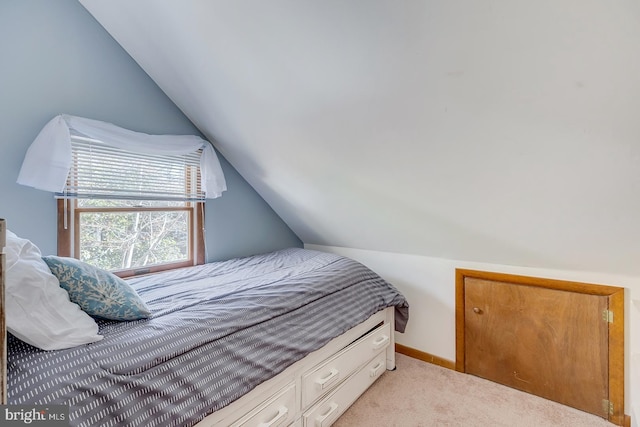 carpeted bedroom featuring vaulted ceiling