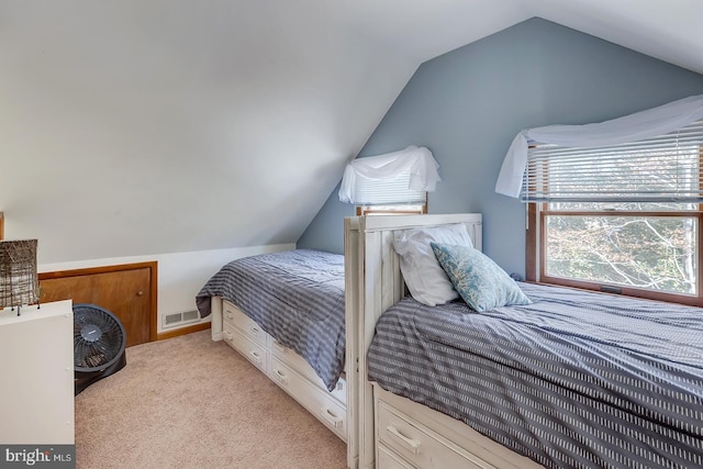 bedroom featuring light carpet and lofted ceiling