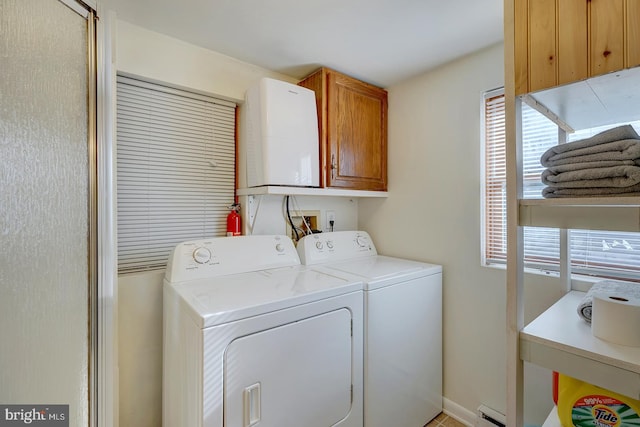 washroom featuring cabinets, independent washer and dryer, and a baseboard radiator