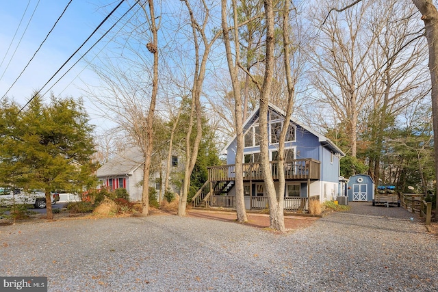 view of front facade with a deck and a storage shed