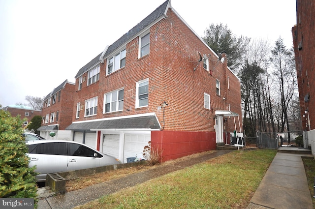 view of side of property with a lawn and a garage