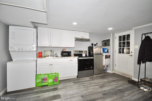 kitchen featuring white cabinets, appliances with stainless steel finishes, stacked washer and clothes dryer, and sink