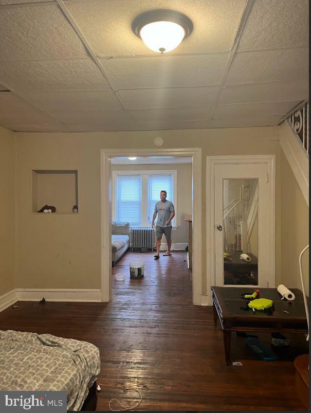 hall featuring radiator heating unit and dark wood-type flooring