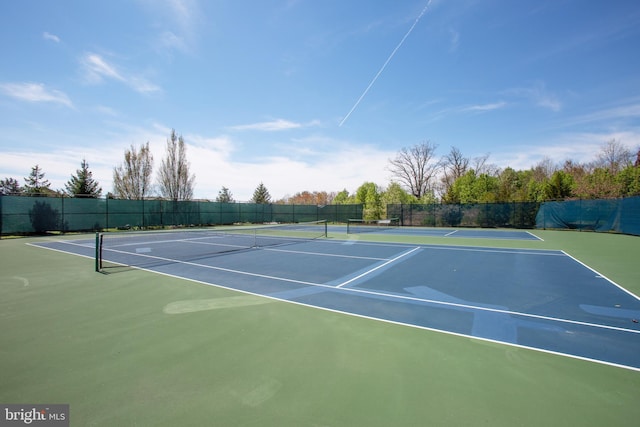 view of tennis court with basketball hoop