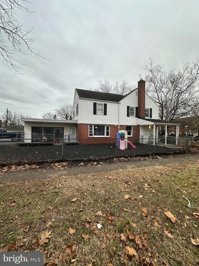 rear view of house featuring a yard