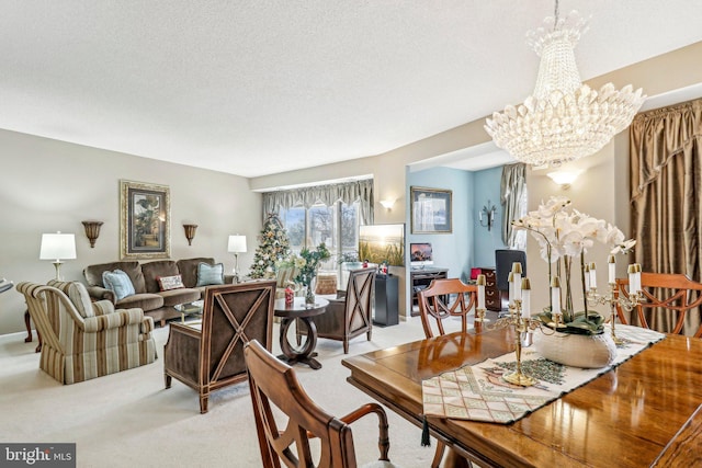 carpeted dining space featuring a chandelier and a textured ceiling