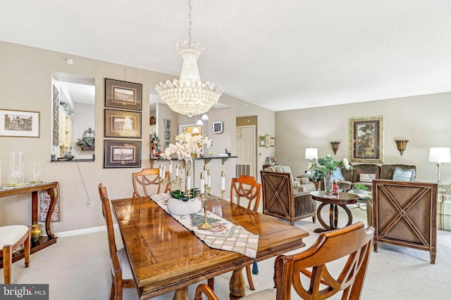 carpeted dining room with a textured ceiling and a chandelier