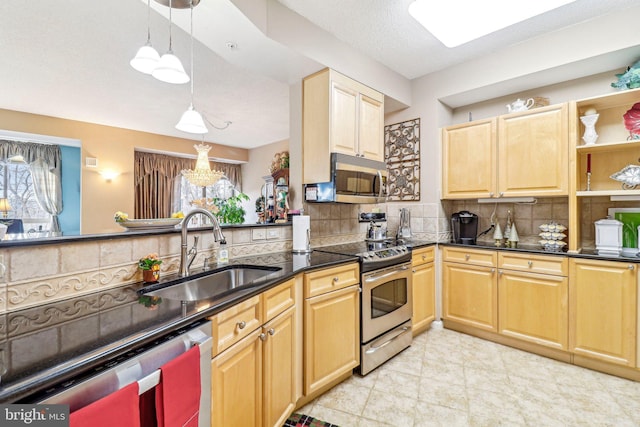 kitchen with appliances with stainless steel finishes, tasteful backsplash, a textured ceiling, sink, and pendant lighting